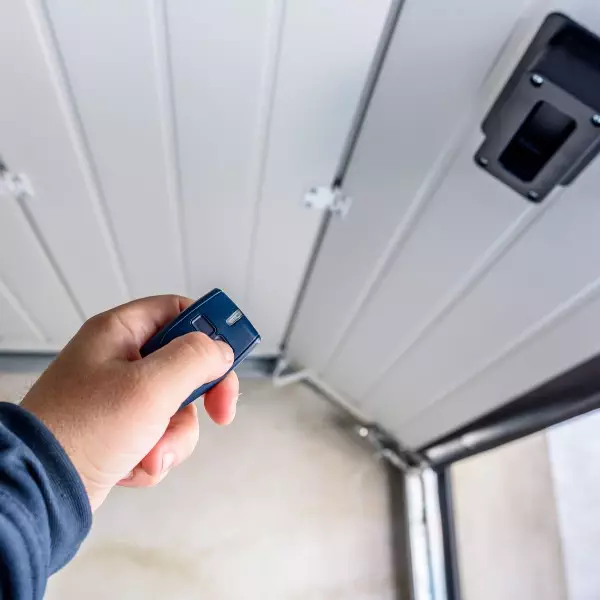 Remote control activates garage door during bright daylight in residential setting Remote control activates garage door during bright daylight in residential setting